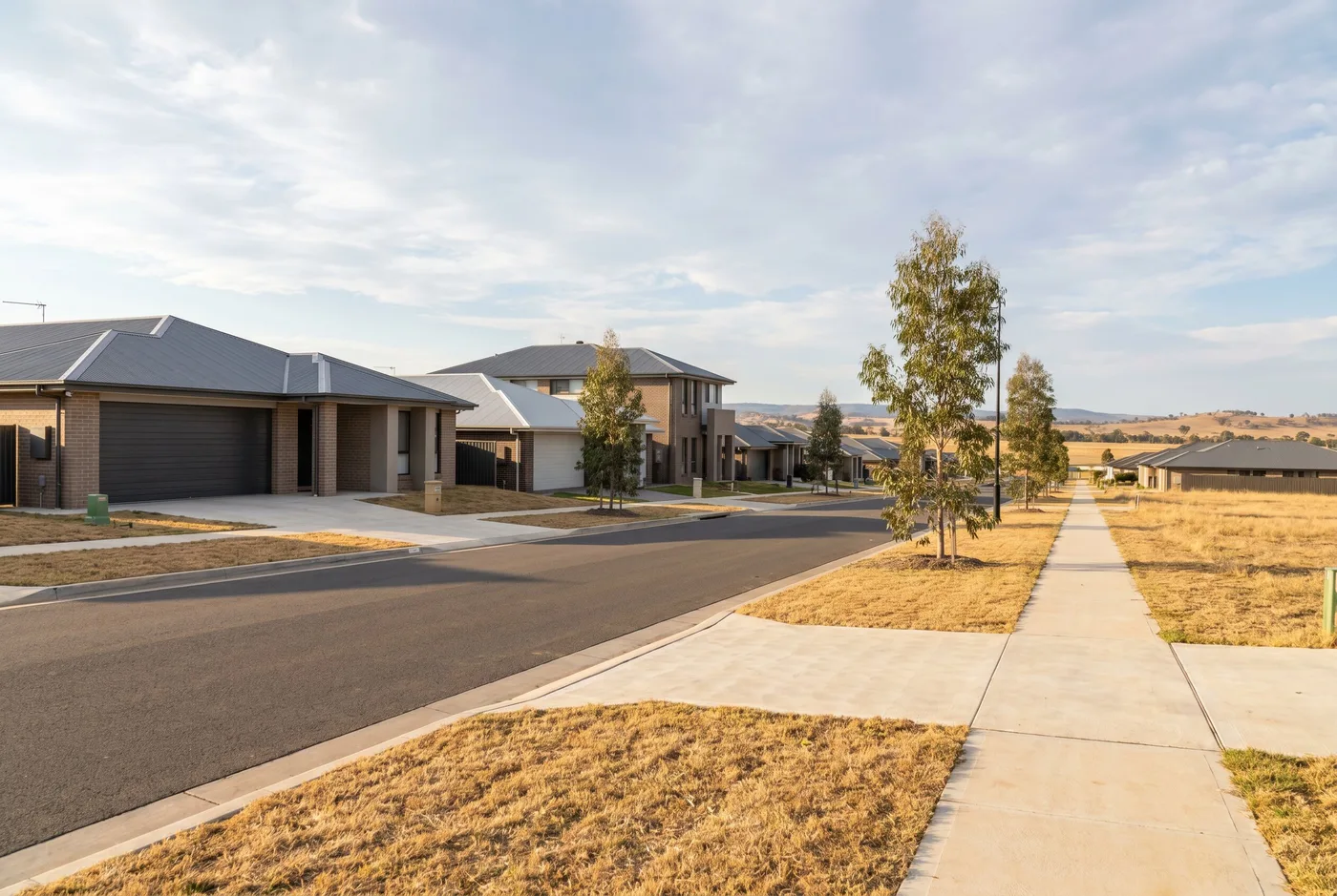 A newer Singleton Heights street of project homes with wide double sectional garage doors